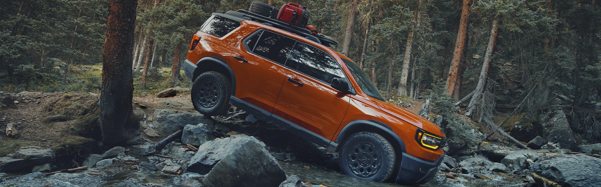 Orange 2026 Honda Passport off road driving