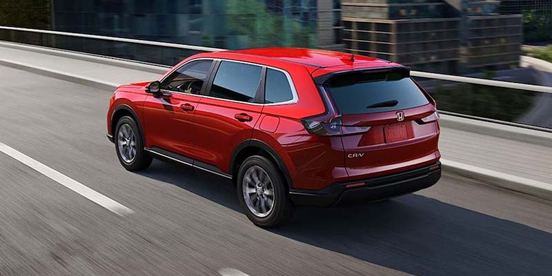 Red 2026 Honda CR-V driving on the street