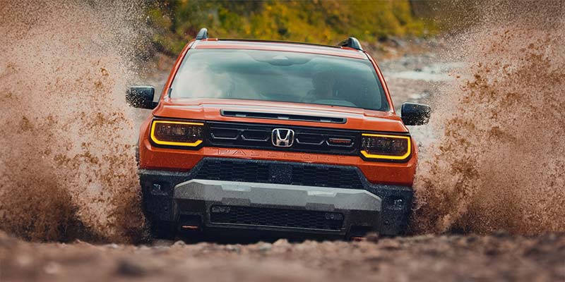 Honda Passport front view driving through the mud