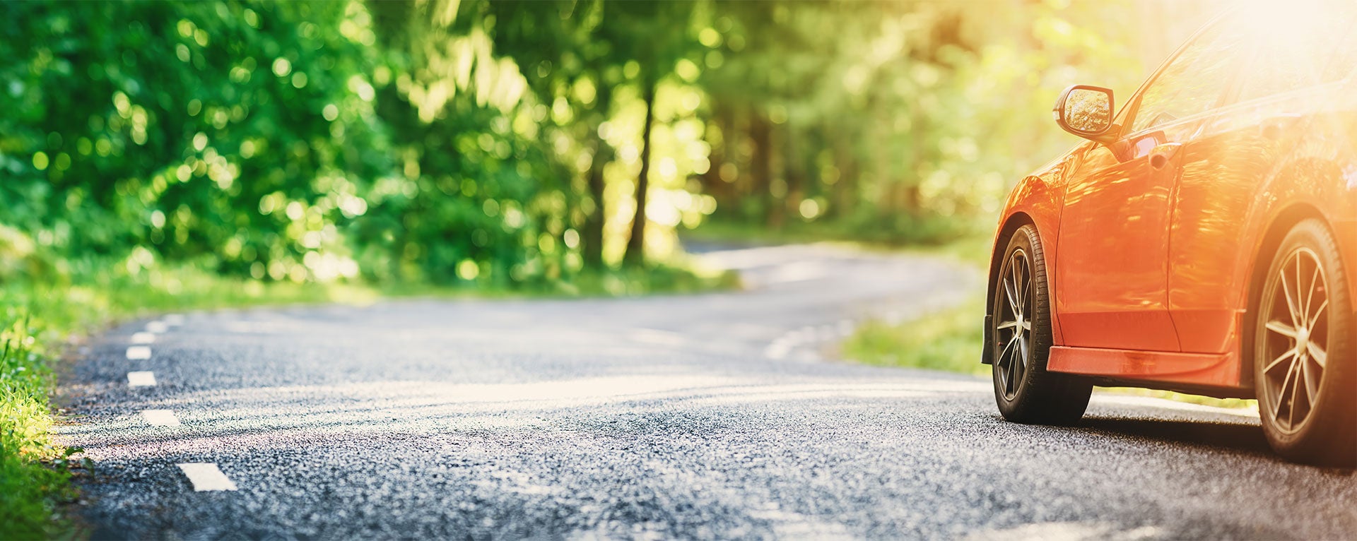 Honda driving along a highway through the trees